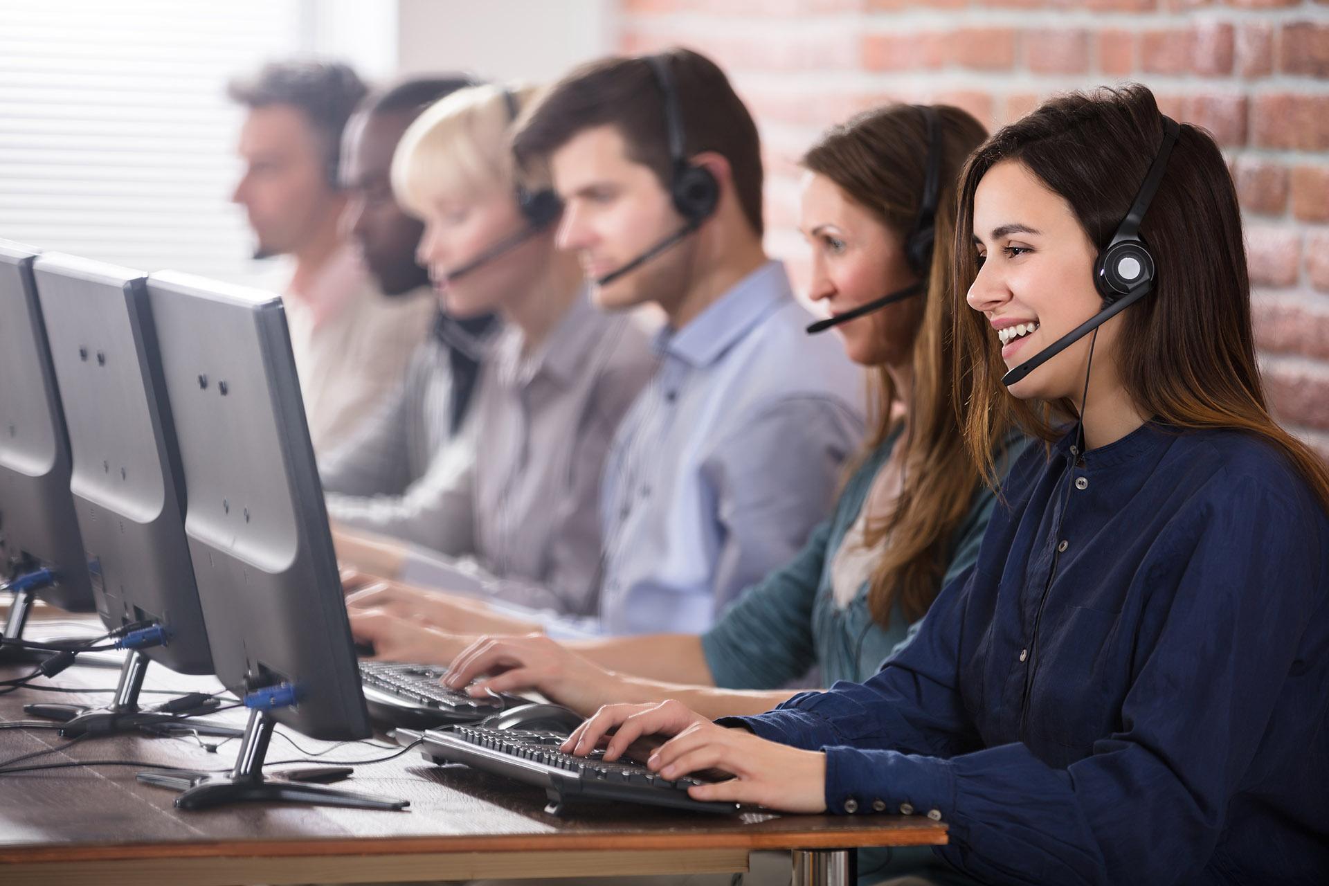 Positive,Female,Customer,Services,Agent,With,Headset,Working,In,A